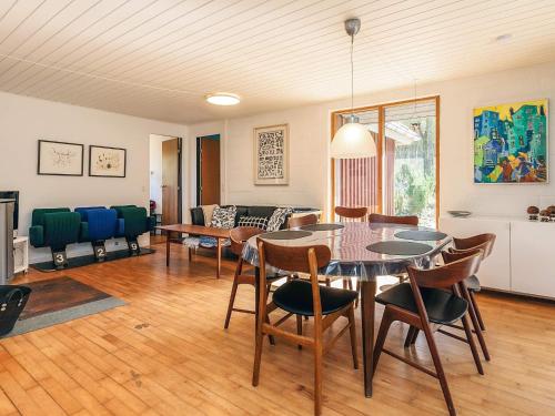 a living room with a table and chairs at 6 person holiday home in Asperup in Asperup