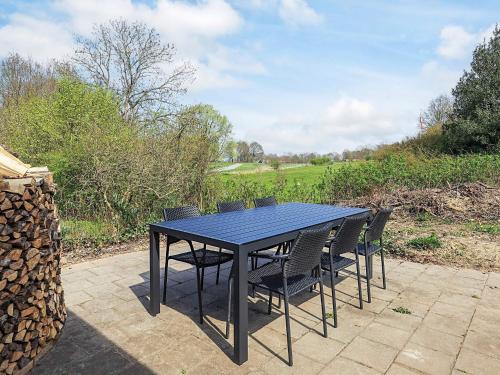 a black table and chairs sitting on a patio at 6 person holiday home in Asperup in Asperup