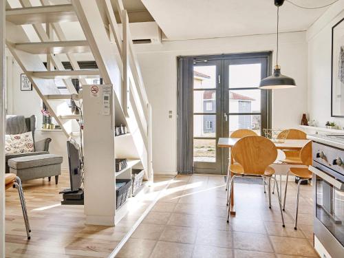 a kitchen and dining room with a table and chairs at 5 person holiday home on a holiday park in Gudhjem in Gudhjem