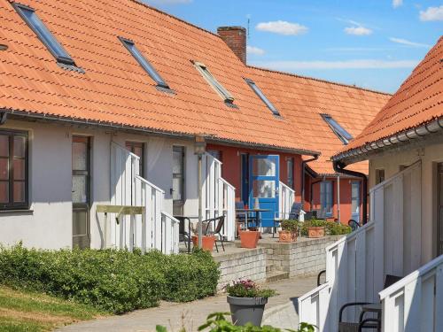 a row of houses with orange roofs at 5 person holiday home on a holiday park in Gudhjem in Gudhjem