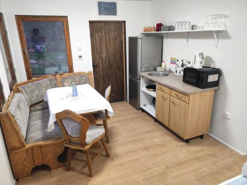 a kitchen with a table and a couch and a table and a kitchen with at Lesní chaty "Hogo Fogo" in Kytlice