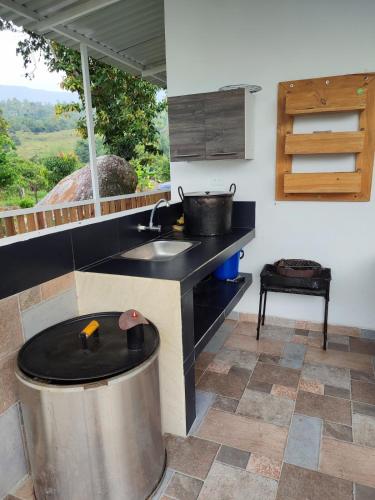 a kitchen with a sink and a counter with a stove at Casa Jaguar Viotá in Viotá