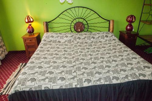 a bed in a bedroom with a bedspread with money at Khweza Bed and Breakfast in Nairobi