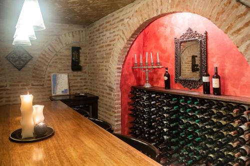 a wine cellar with a table and a wall of wine bottles at Miravida Soho Hotel & Wine Bar in Buenos Aires