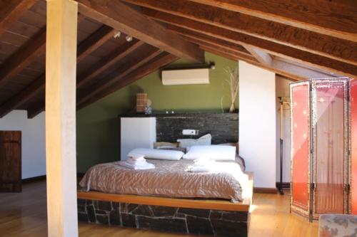 a bedroom with a large bed in a room at Las cabachuelas casas rurales in San Miguel de Valero