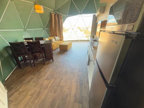 a kitchen and living room with a table and chairs at Bryce Glamp And Camp in Cannonville