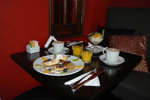 a table with a plate of food and drinks on it at Miravida Soho Hotel & Wine Bar in Buenos Aires