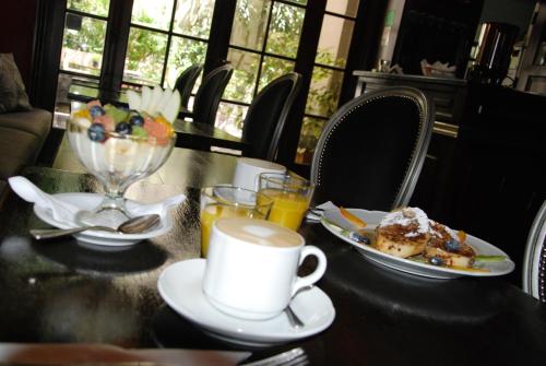 a table with a plate of food and a cup of coffee at Miravida Soho Hotel & Wine Bar in Buenos Aires
