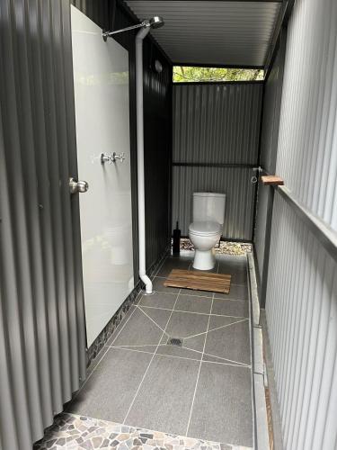a bathroom with a toilet inside of a building at South West Rocks Gap Beach Studio in Arakoon