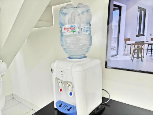 a vase sitting on top of a refrigerator at Cozy 1BR Casa De Parco Apt with Pool & Gym in Samporo