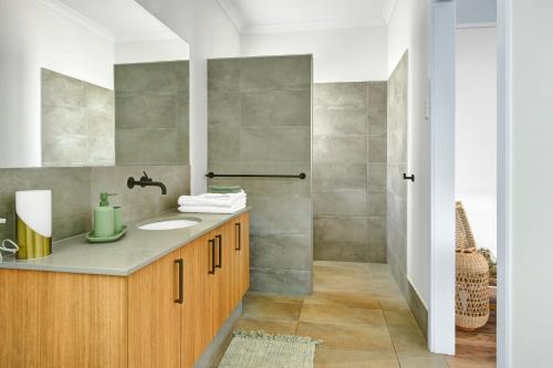 a bathroom with a sink and a shower at The Sandpiper Escape in Broome