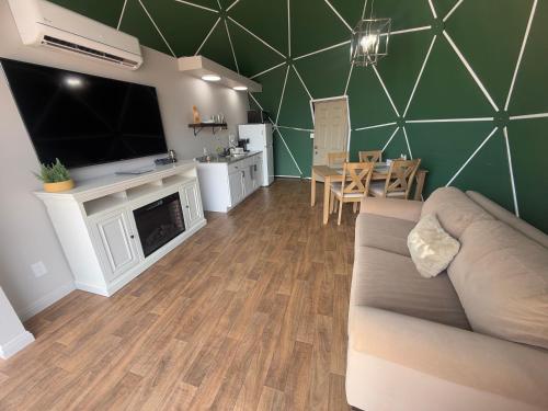 a living room with a couch and a tv and a table at Bryce Glamp And Camp in Cannonville