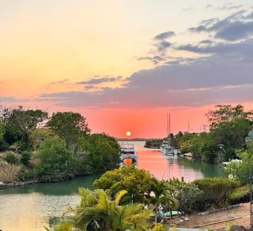 a river with boats in it at sunset at wonderful house in Marina Baru in Cartagena! in Isla Barú