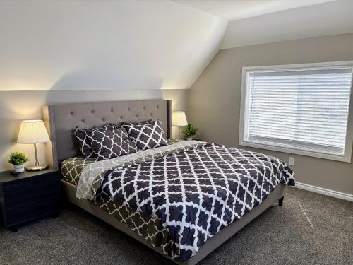 a bedroom with a large bed and a window at Nice and cozy whole house 25min to Niagara falls in Buffalo