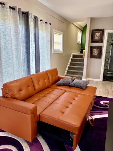 a living room with a brown leather couch at Nice and cozy whole house 25min to Niagara falls in Buffalo