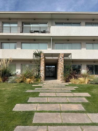 a building with a stone pathway in front of it at Andes Vista Mendoza in Ciudad Lujan de Cuyo