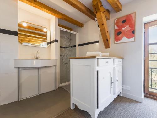 a bathroom with white cabinets and a sink at Grande maison de campagne rénovée avec parking et espace détente - FR-1-306-1303 in Malville