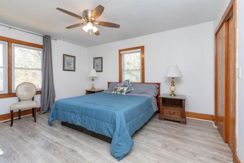 a bedroom with a blue bed and a ceiling fan at Red Robin Retreat - Near Lake James, NC in Morganton