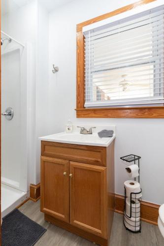 a bathroom with a sink and a window at Red Robin Retreat - Near Lake James, NC in Morganton
