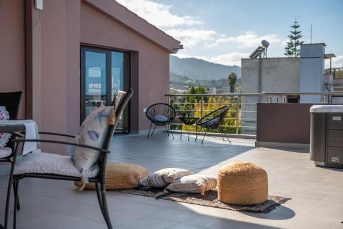 a patio with chairs and a balcony with a view at Angela Home, 5Street, Perivolia in Perivólia