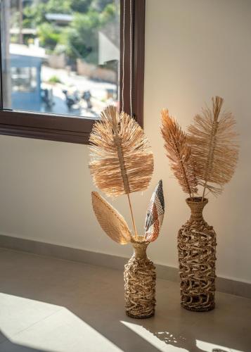 three vases sitting on a table next to a window at Angela Home, 5Street, Perivolia in Perivólia
