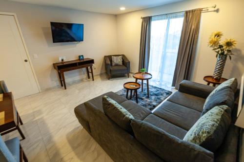 a living room with a couch and a table at The Residences by Morgan in Cabo San Lucas