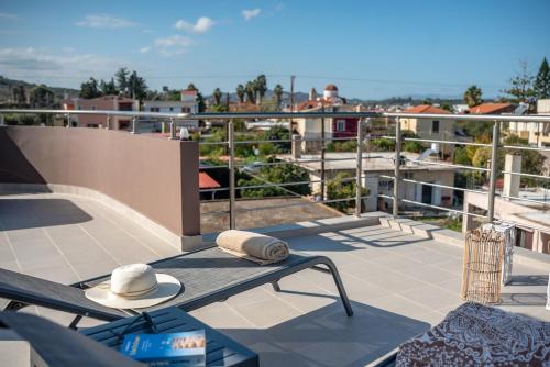 two hats sitting on a table on a balcony at Angela Home, 5Street, Perivolia in Perivólia