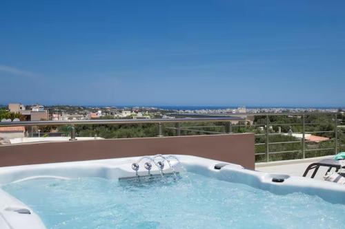 a hot tub on a balcony with a view at Angela Home, 5Street, Perivolia in Perivólia