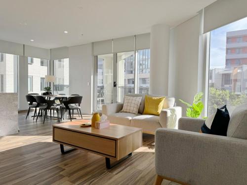 a living room with a couch and a table at Entire Apartment in Zetland in Sydney