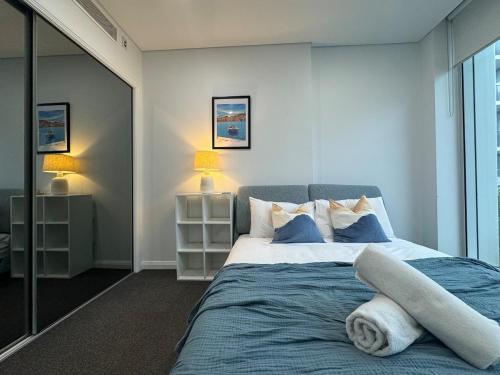a bedroom with a bed with a towel on it at Entire Apartment in Zetland in Sydney