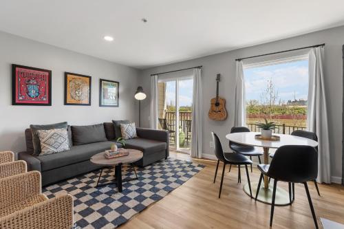 a living room with a couch and a table at Nashville Oasis Walk to Broadway with POOL, Parking, Gym and Patio in Nashville