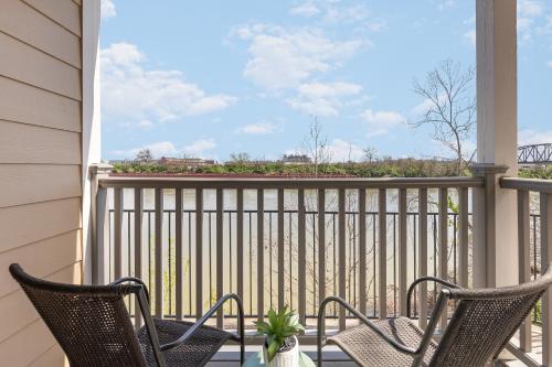 a porch with two chairs and a table at Nashville Oasis Walk to Broadway with POOL, Parking, Gym and Patio in Nashville