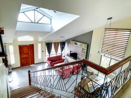 a view of a living room with a ceiling at JResidences - 5 Bedrooms Cozy Home in Bacolod