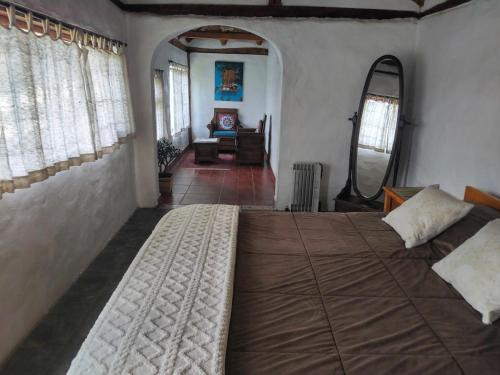 a bedroom with a large bed in a room at Cabaña en la Montaña in Otavalo