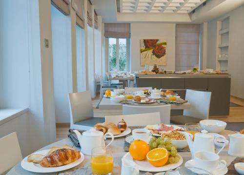 a breakfast table with breakfast foods on it at Hotel Di Varese in Varese