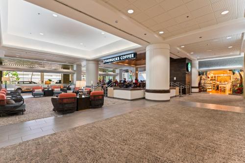 a lobby of a mall with chairs and a store at Ala Moana Hotel Condo 15th floor in Honolulu