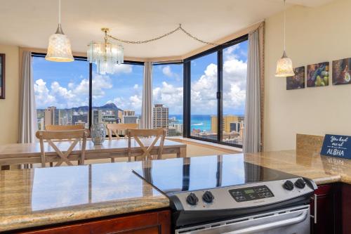 a kitchen with a view of the ocean at Hawaiian Monarch Penthouse 402 in Honolulu