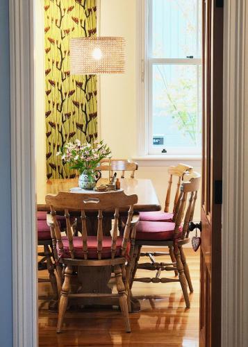 a dining room with a table and chairs and a window at Luxury new 3 bedroom house in central city 5 star in Christchurch