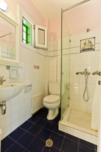 a bathroom with a toilet and a sink and a shower at Aretousa Studios & Apartments in Skopelos Town