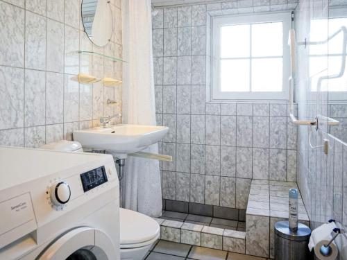 a bathroom with a sink and a washing machine at 4 person holiday home in Allinge-By Traum in Allinge