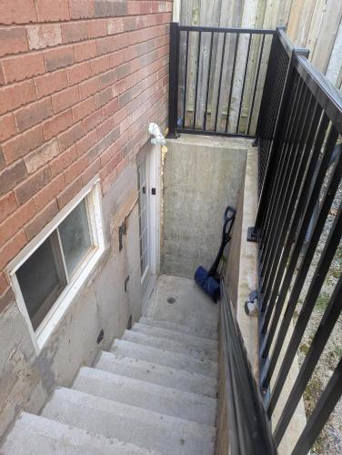 a staircase leading up to a brick building at Basement two Queen beds and one single with two full washrooms by YKF airport in Kitchener