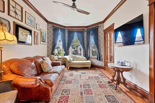 a living room with a leather couch and a table at Vintage 3 Bed Condo in Chicagolands Trendy Berwyn condo in Berwyn