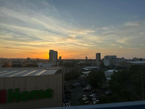 a view of a city at sunset with a building at 8F Cozy 1-Bedroom Unit The Loop Towers in Cagayan de Oro
