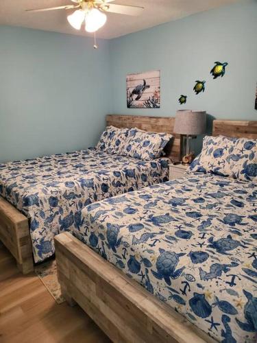 a bedroom with two beds and a ceiling fan at Seas the day llc in Myrtle Beach