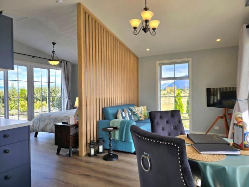 a bedroom with a bed and a desk with a laptop at Kahurangi Cottage Twizel in Twizel