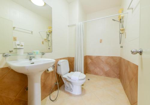 a bathroom with a toilet and a sink and a shower at Sun and beach hotel in Pattaya South