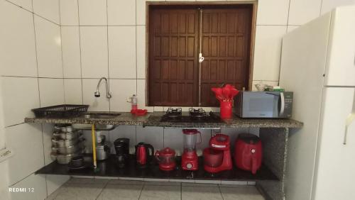 a kitchen with a counter with red appliances on it at Recanto Machado in Paraty