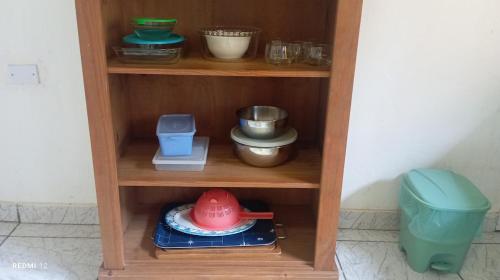 a wooden shelf with bowls and other items on it at Recanto Machado in Paraty
