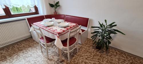 a table with a red and white table cloth at Apartmány Zelená Hora s velkou zahradou in Žďár nad Sázavou