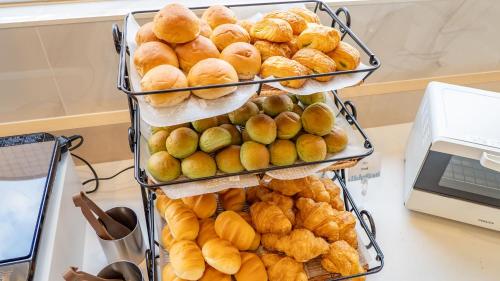 a pile of breads and pastries on a table at Toyoko Inn Kobe Sannomiya Ekimae in Kobe